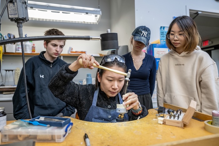 teacher showing jewelry process