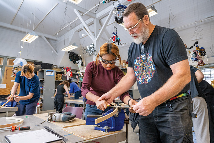 teaching showing woodworking technique