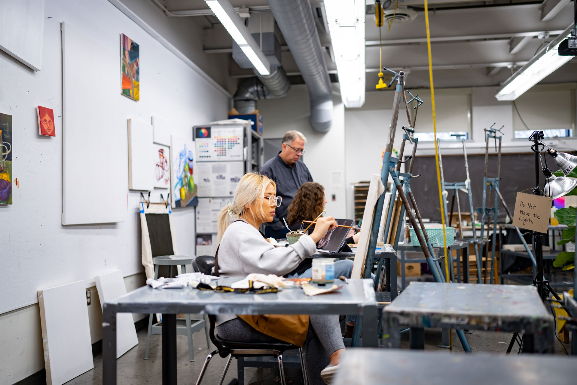 students painting in classroom