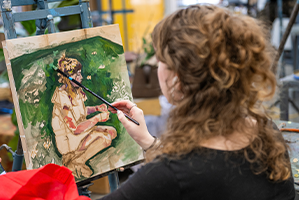 student working on a painting