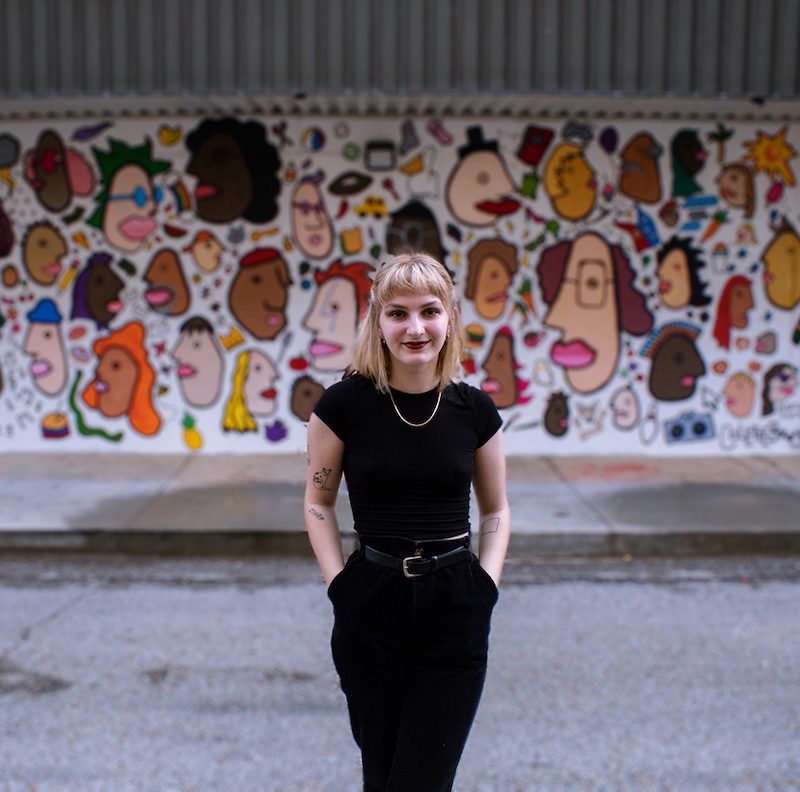 Colette Bernard standing in front of mural