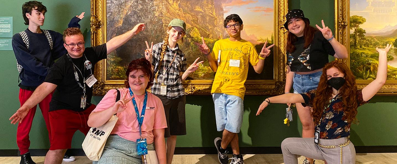 group of students in front of painting posing at munson museum of art