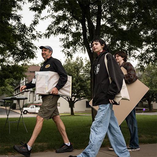 parents and students walking down sidewalk