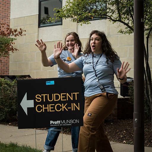 people standing at student check in sign