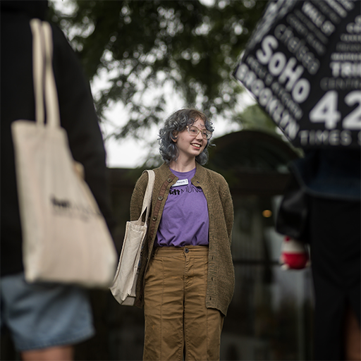 student standing in purple 