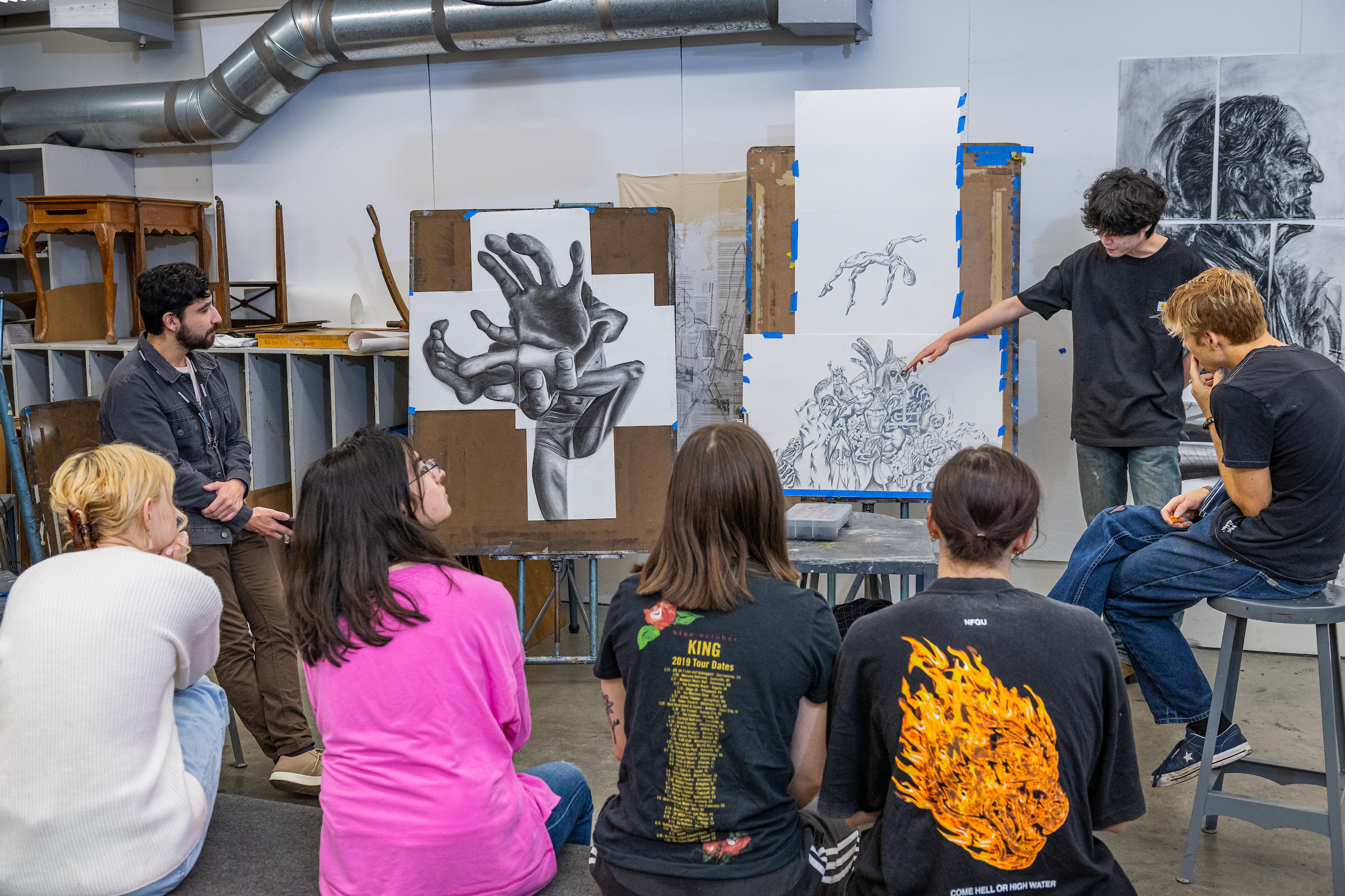 students looking at artwork critiquing